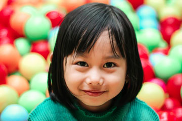 Girl smiling in ball pit